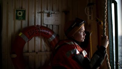 Hanna Jauhiainen, a Greenpeace activist, looks outside the window from aboard the Esperanza ship, near Quentin Point, Anvers Island, Antarctica. REUTERS