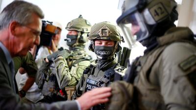 Former German Interior Minister Thomas de Maiziere speaks with members of Bundespolizei, Germany's federal police. Reuters.