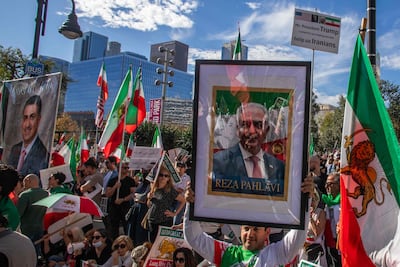 Protesters hold up a picture of Reza Pahlavi during a demonstration in California. AFP