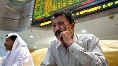 Traders on the trading floor of the ADX. Nicole Hill / The National