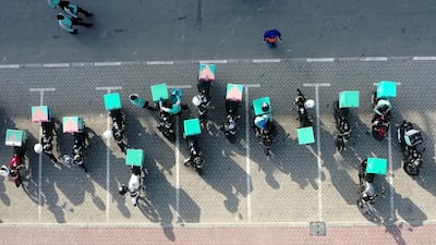 Motorbikes of a delivery company line up in Dubai. AFP