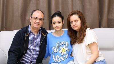 The first vertebral body tethering procedure was performed on Salma Naser Nawayseh, centre, with her parents, at Burjeel Hospital in Dubai