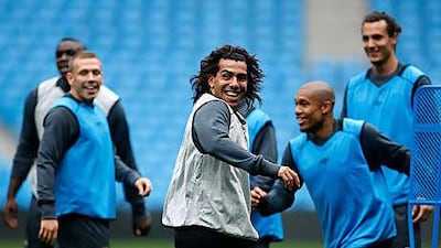 Members of Manchester City's squad, including Carlos Tevez, centre, enjoy a relaxed training session ahead of today's opening game of the new Premier League season against Tottenham Hotspur.