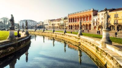 Statues and palaces in Prato della Valle, Padua. The most impressive is Palazzo del Bo, which is the university’s main building. Getty Images