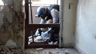 A UN expert collects samples in the Ghouta suburb of Damascus in 2013, during an investigation into a suspected chemical weapons attack on the area two weeks earlier. AFP