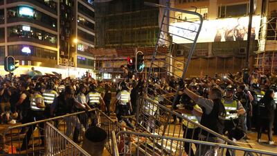 Riot police clear the barriers built by protesters in the occupied Mong Kok area. Kin Cheung/AP Photo