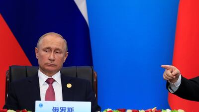 Russia's President Vladimir Putin looks on as China's President Xi Jinping points during Shanghai Cooperation Organisation (SCO) summit in Qingdao, Shandong Province, China on June 10, 2018. Aly Song / Reuters
