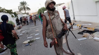 epa02878747 Libyan rebel fighters enter the Bab al-Aziziya compound, the main stronghold of Gaddafi, in Tripoli, Libya, on 23 August 2011. Libyan rebels fired celebratory rounds in the air later after capturing the palace of embattled leader Muammar Gaddafi following days of fighting in Tripoli. The rebels were heard singing, shouting 'God is Great' and honking their cars, as plumes of black smoke rose from the Bab al-Aziziya compound. EPA/MARCO SALUSTRO *** Local Caption *** 02878747.jpg