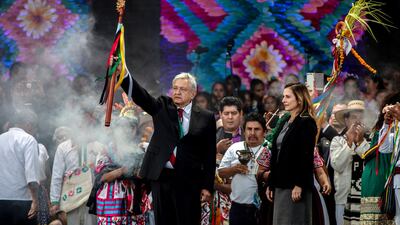 Andres Manuel Lopez Obrador holds up a ceremonial wooden staff during the 58th presidential inauguration event at the central plaza, known as the Zocalo, in Mexico City. Bloomberg