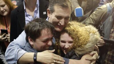 Republican presidential candidate, Senator Ted Cruz, hugs Arden Jurskis and Kenzy Peach after Arden proposed to Kenzy in front of Cruz at a campaign event at Iowa State Fairgrounds on Sunday. Chris Carlson / AP