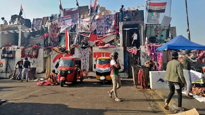 Anti-government protesters sit-in on barriers set up by security forces to close a bridge leading to the Green Zone government areas during ongoing protests, in Baghdad, Iraq. AP Photo