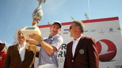 Justin Rose, centre, poses with the trophy after winning the Turkish Airlines World Golf Final by a shot over Lee Westwood.