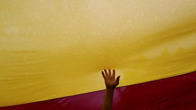 A man touches a Spanish flag during a demonstration in favour of a unified Spain a day before the banned October 1 independence referendum, in Barcelona, Spain. Susana Vera / Reuters
