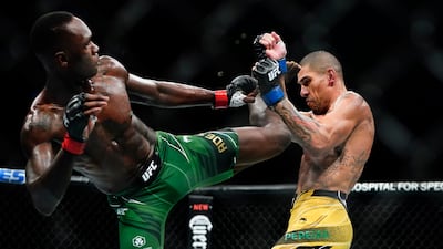 Alex Pereira blocks a kick by Israel Adesanya during the third round. AP