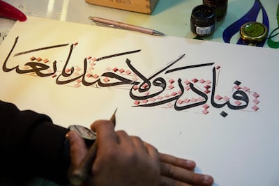 Iraqi calligrapher Wael Ramadan uses a stylus to produce a sample of Arabic calligraphy at his workshop in al-Ashar district of Basra, Iraq.