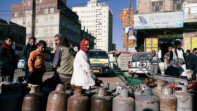 People wait to fill their cooking gas cylinders outside a gas filling station amid a scarcity in cooking gas supplies in Sanaa, Yemen March 4, 2018. Reuters