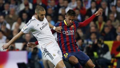 Real Madrid's Karim Benzema, left, fights for the ball against Barcelona's Neymar during their Spanish Primera Liga match at Santiago Bernabeu stadium in Madrid on March 23, 2014. Paul Hanna / Reuters