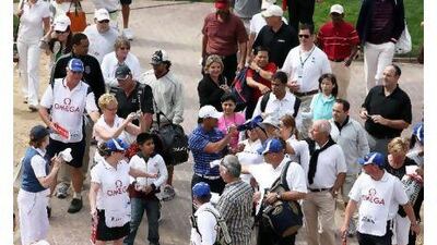 Tiger Woods signs autographs for fans during the pro-am golf at the Emirates Golf Club today. Pawan Singh / The National