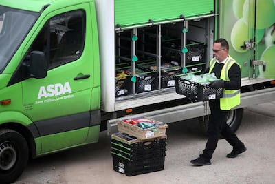 An Asda employee makes a delivery. Reuters
