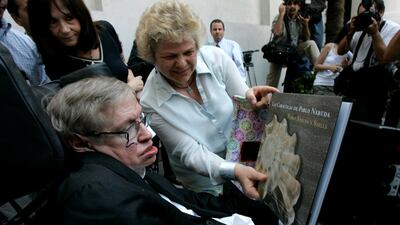 British physicist Stephen Hawking looks at a book of Chile's Nobel Laureate Pablo Neruda after a meeting with Chile's President Michelle Bachelet (unseen) at the Presidential Palace in Santiago on January 17, 2008. Victor Ruiz Caballero / Reuters