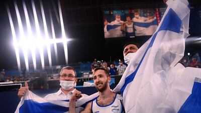 Israel's Artem Dolgopyat (C) celebrates with his team after winning the floor event of the artistic gymnastics men's floor exercise final.