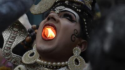 An Indian Hindu man dressed as Lord Shiva holds a lit candle in his mouth as he takes part in a religious procession ahead of the Maha Shivratri Festival in Jalandhar. Hindus mark the Maha Shivratri festival by offering special prayers and fasting to worship Lord Shiva, the lord of destruction. Shammi Mehra / AFP