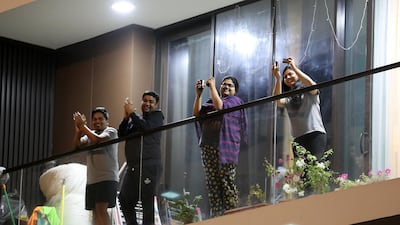 UAE residents cheering from their balconies and homes on Wednesday night at Al Mankhool area in Bur Dubai. Pawan Singh / The National