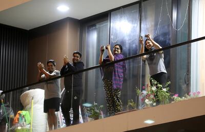 Residents cheering from their balcony on Wednesday, March 25 in Al Mankhool. Pawan Singh / Bur Dubai