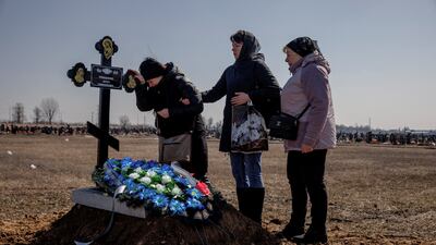 Family members of Borys Romanchenko attend the funeral of the Holocaust survivor in Kharkiv, Ukraine. Romanchenko was killed by Russian shelling, aged 96. Reuters