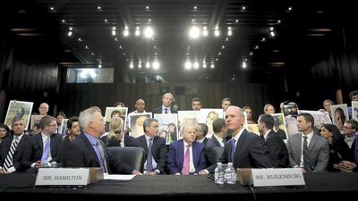 Family members of those who died aboard Ethiopian Airlines Flight 302 hold photographs of their loved ones as Dennis Muilenburg, President and chief executive of the Boeing Company, and John Hamilton, Vice President and Chief Engineer of Boeing Commercial Airplanes, testify before the Senate Commerce on October 29, 2019 in Washington DC. Getty Images