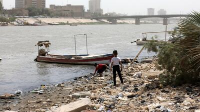 Iraqi boys play on the banks of the Tigris, which is contaminated with sewage and rubbish, in Baghdad. EPA