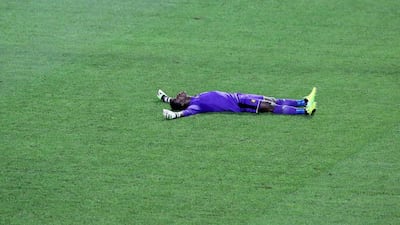 Cameroon goalkeeper Fabrice Ondoa lies on the pitch as he celebrates after Cameroon beat Egypt 2-1 in the 2017 Africa Cup of Nations final. Steve Jordan / AFP