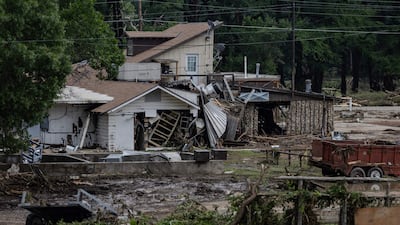 A home covered in debris sits near the town centre. AFP