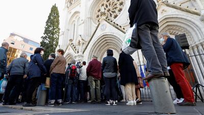People gather in front of the Notre Dame church. Reuters