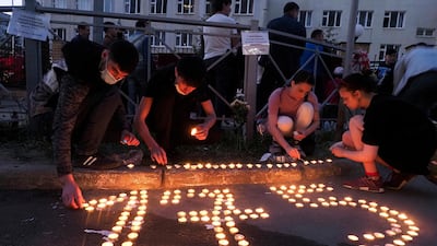 People place candles to form the number 175, after a shooting at school No 175 in the city of Kazan, in south-west Russia. Seven children and two adults were killed. A 19-year-old suspect was detained. AP Photo
