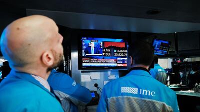 Traders work on the floor of the New York Stock Exchange. Over the past week, all the US indices have hit circuit breakers. AFP