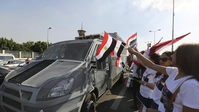 Supporters of Abdel Fattah El Sisi cheer police vehicles during a pre-election rally in front of the Monument to the Unknown Soldier in Cairo’s Nasr City district on May 23, 2014, the last day of campaigning for the May 26-27 presidential election. Mohamed Abd El Ghany/ Reuters