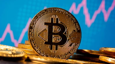 A representation of bitcoin is seen in front of a stock graph in this illustration taken November 19, 2020. Reuters