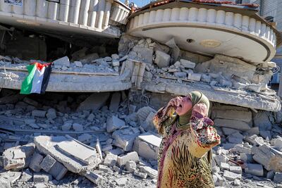 A Palestinian woman stands outside the demolished Shalabi family home.