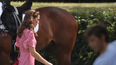 The Duchess of Cambridge runs after her son, Prince Louis. AP