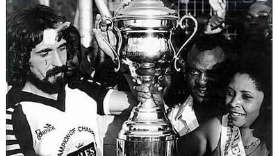 Andy Karacinski lifts 1981 Champion of Champions Trophy.