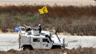 Spanish UN peacekeepers patrolling along the Lebanese-Israeli border pass a Hezbollah flag in the southern Lebanese village of Kfar Kila. AP