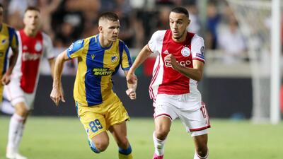 APOEL Nicosia's Roman Bezjak fights for the ball against Ajax Amsterdam's Noussair Mazraoui. EPA