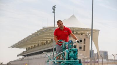 A painter lays down a fresh coat of Yas Blue on the circuit. Courtesy Yas Marina Circuit