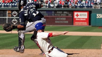 Mike Fontenot slides past Milwaukee's Martin Maldonado to score the winning run for Philadelphia