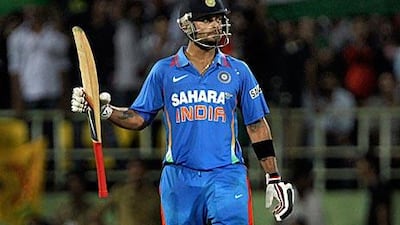 India’s Virat Kohli, whose century helped India to victory, raises his bat after passing the 50 mark yesterday.