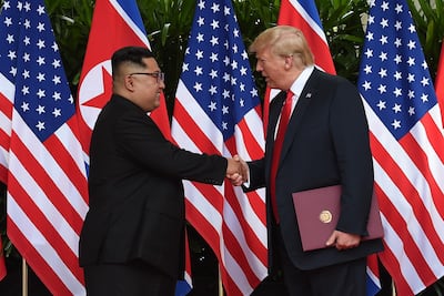 North Korea's leader Kim Jong Un shakes hands with US President Donald Trump after taking part in a signing ceremony at the end of their historic US-North Korea summit, ain Singapore on June 12, 2018. Anthony Wallace / AFP