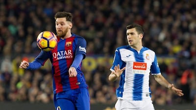 Lionel Messi controls the ball in front of Espanyol defender Aaron Martin. Marta Perez / EPA