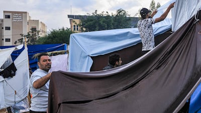 A tent pitched in Khan Younis in the southern Gaza Strip is covered with insulating plastic by Palestinians taking shelter amid Israeli bombardment around Nasser Hospital. AFP