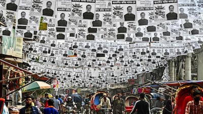 Posters of the election candidates hanging over a street ahead of the 2024 general elections, in Dhaka on December 26. AFP